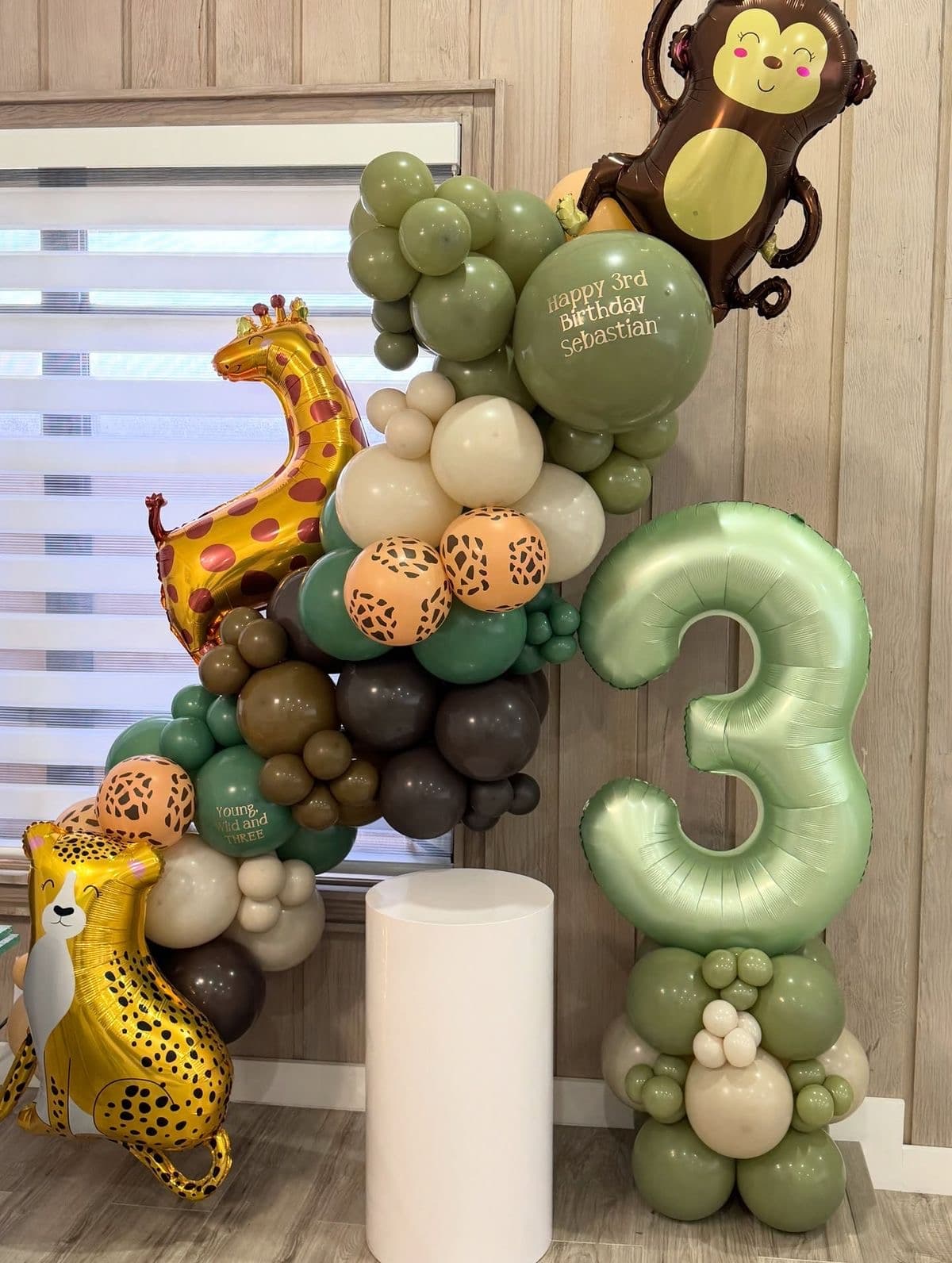 Statement Jovira balloon arch backdrop framed by two styled photo moments