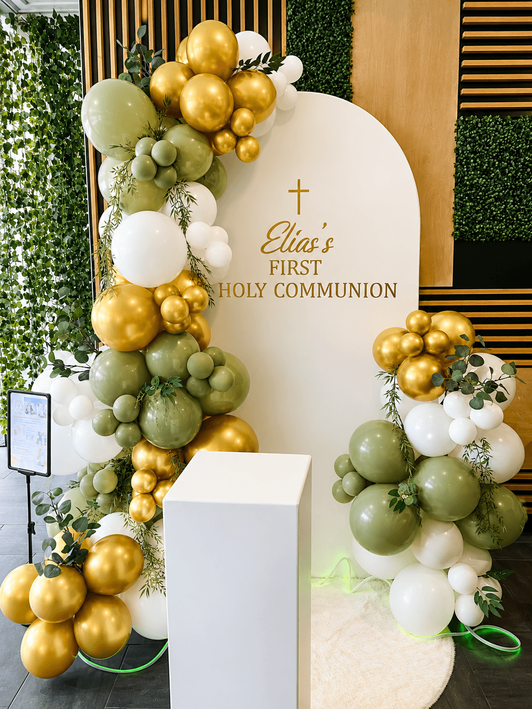 Evergreen Christmas garland with champagne baubles above a styled entrance moment