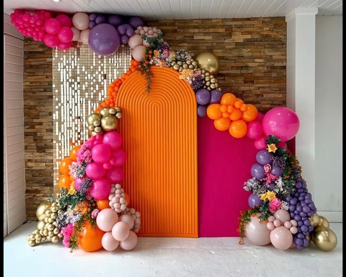 Full-scale Jovira transformation with an entrance arch, photo wall, and multiple styled zones